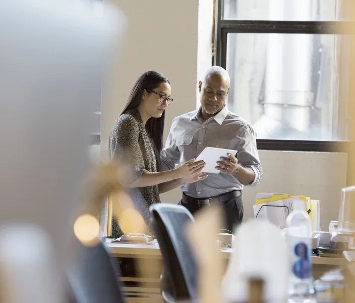 Two colleagues review a document together